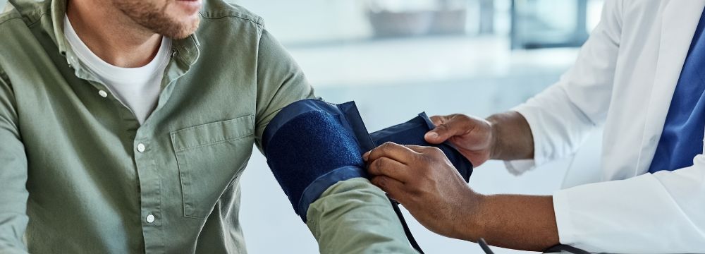 Man getting blood pressure taken by a nurse