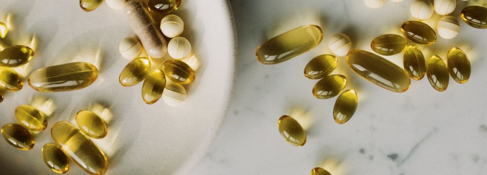 Omega - 3 supplements in bowl and on table