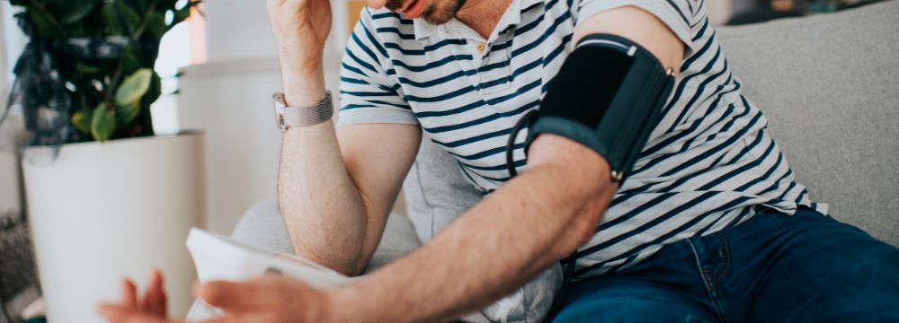 Man sitting down taking blood pressure