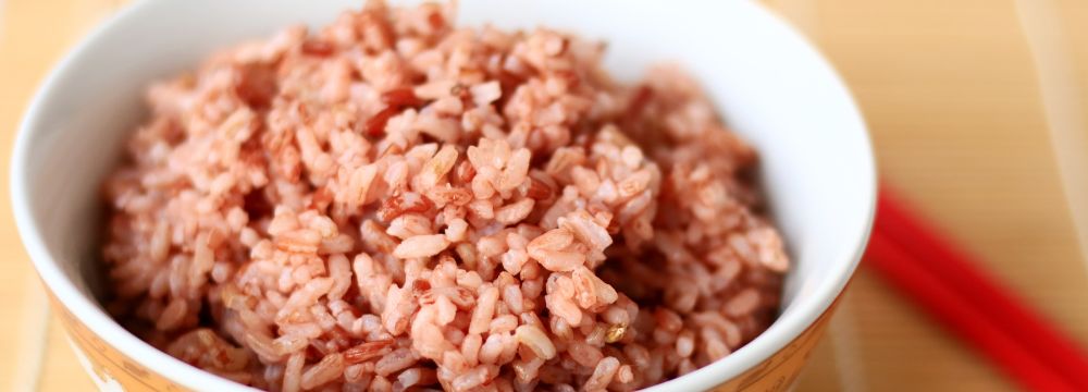 Bowl of red yeast rice on table 