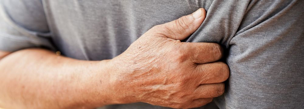 Man grabbing chest with one hand